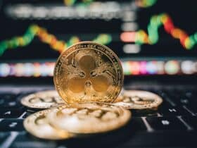 Golden Ripple XRP coins on laptop, symbolizing cryptocurrency trends and online trading.