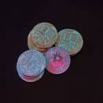 A detailed image showcasing a stack of Bitcoin cryptocurrency coins on a black background.