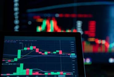 Close-up view of digital trading chart screen with vibrant graphs and data analysis.