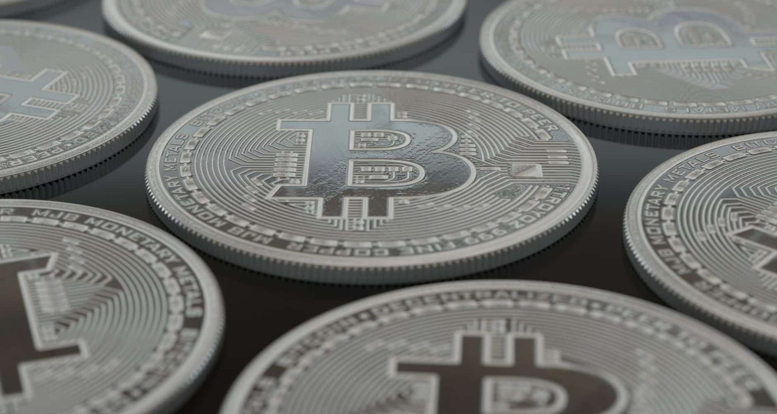 Detailed close-up of silver Bitcoin coins showcasing digital currency concepts.