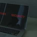 Close-up of a laptop displaying cybersecurity text, emphasizing digital security themes.