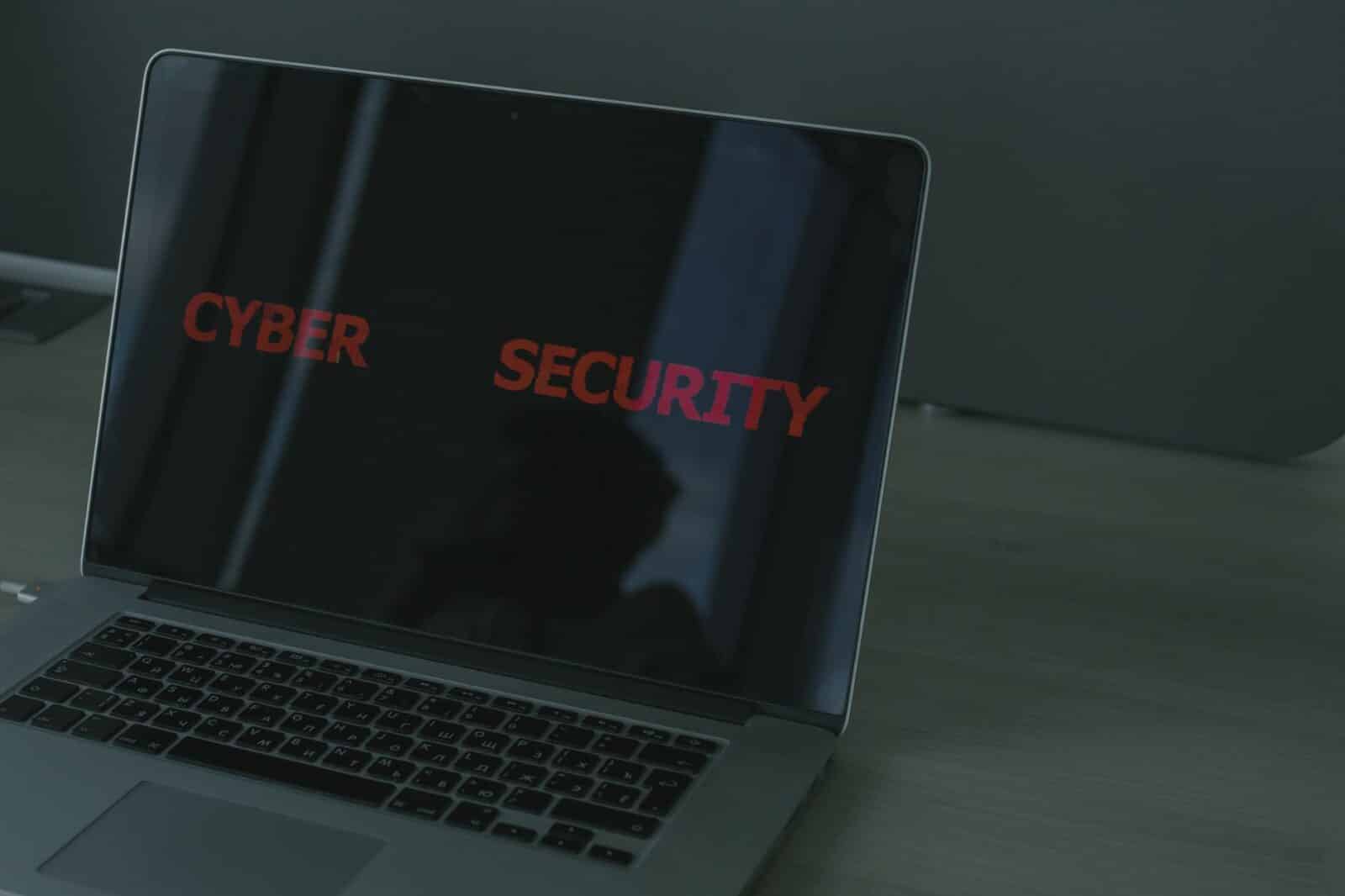 Close-up of a laptop displaying cybersecurity text, emphasizing digital security themes.