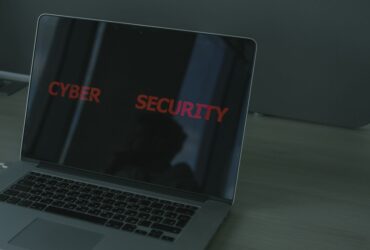 Close-up of a laptop displaying cybersecurity text, emphasizing digital security themes.