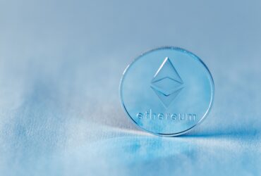 Close-up of a transparent Ethereum coin symbolizing blockchain technology and modern finance.