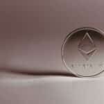 Close-up of a silver Ethereum coin symbolizing digital currency and blockchain technology.