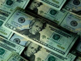 Close-up of multiple US twenty dollar bills depicting wealth and finance.