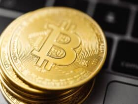 Close-up image of Bitcoin coins stacked on a laptop keyboard, symbolizing digital currency and blockchain technology.