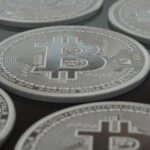 Detailed close-up of silver Bitcoin coins showcasing digital currency concepts.