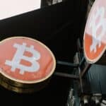 Close-up view of outdoor bitcoin symbol signs, reflecting modern cryptocurrency trends.
