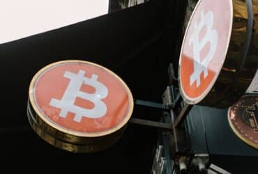 Close-up view of outdoor bitcoin symbol signs, reflecting modern cryptocurrency trends.