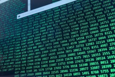 Vibrant green numbers on a computer screen, showcasing binary code and data streams.