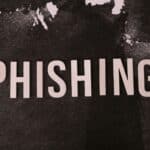 Abstract representation of phishing with the text on a textured dark surface.