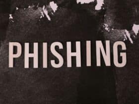 Abstract representation of phishing with the text on a textured dark surface.