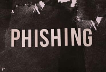 Abstract representation of phishing with the text on a textured dark surface.