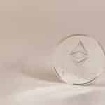 Close-up of an Ethereum coin on a soft, neutral background symbolizing modern cryptocurrency.