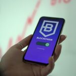 Hand holding smartphone displaying blockchain cryptocurrency wallet.