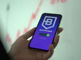 Hand holding smartphone displaying blockchain cryptocurrency wallet.