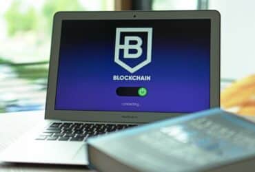 Laptop with blockchain application interface connecting. Ideal for tech and crypto themes.