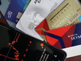Image showing credit cards and a financial market graph on a smartphone.