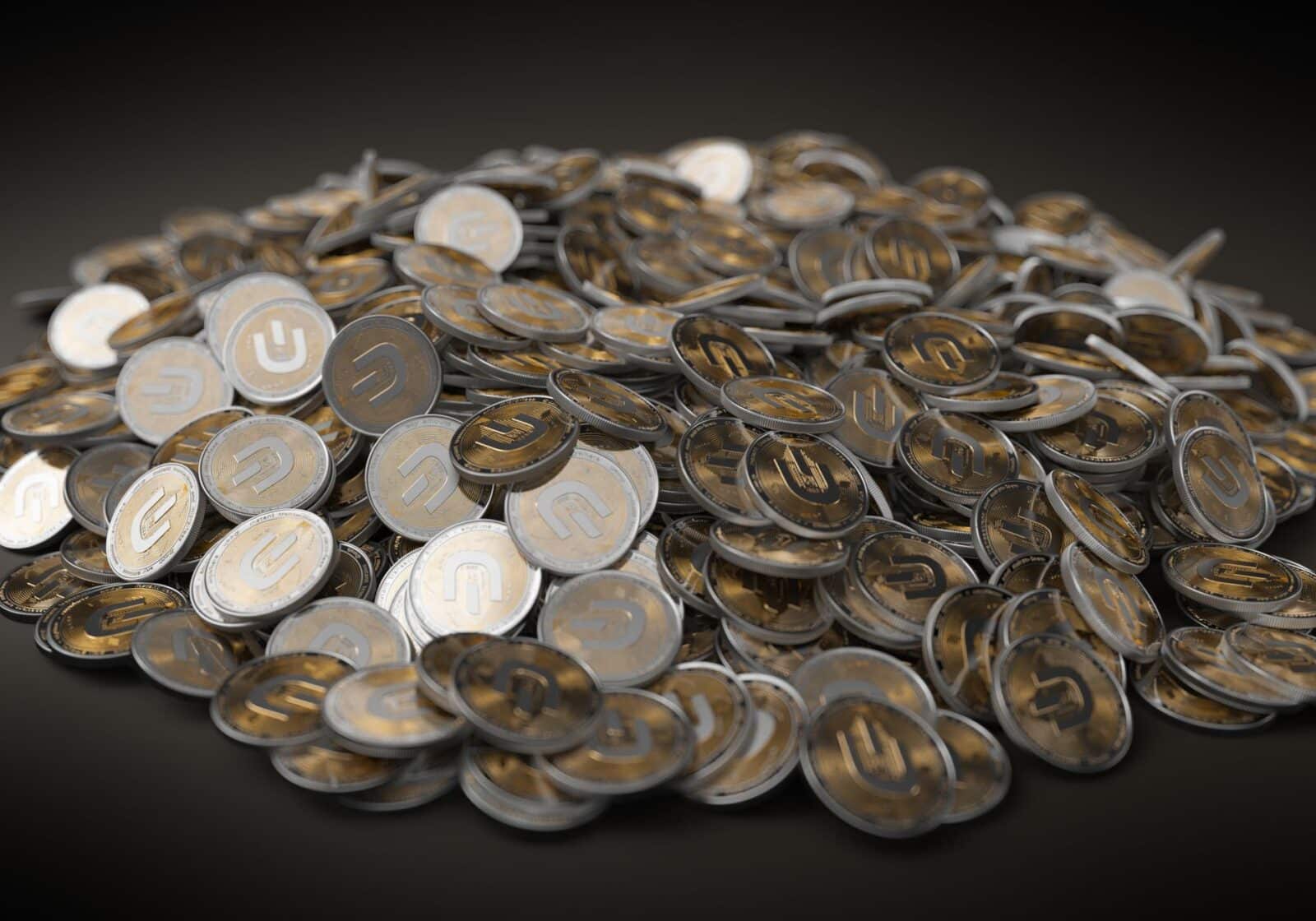 A close-up view of a large pile of gold and silver cryptocurrency coins indicating financial wealth.