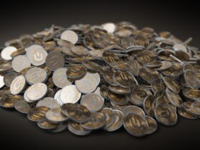 A close-up view of a large pile of gold and silver cryptocurrency coins indicating financial wealth.