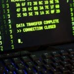 Data transfer complete message displayed on a computer monitor with a keyboard underneath.
