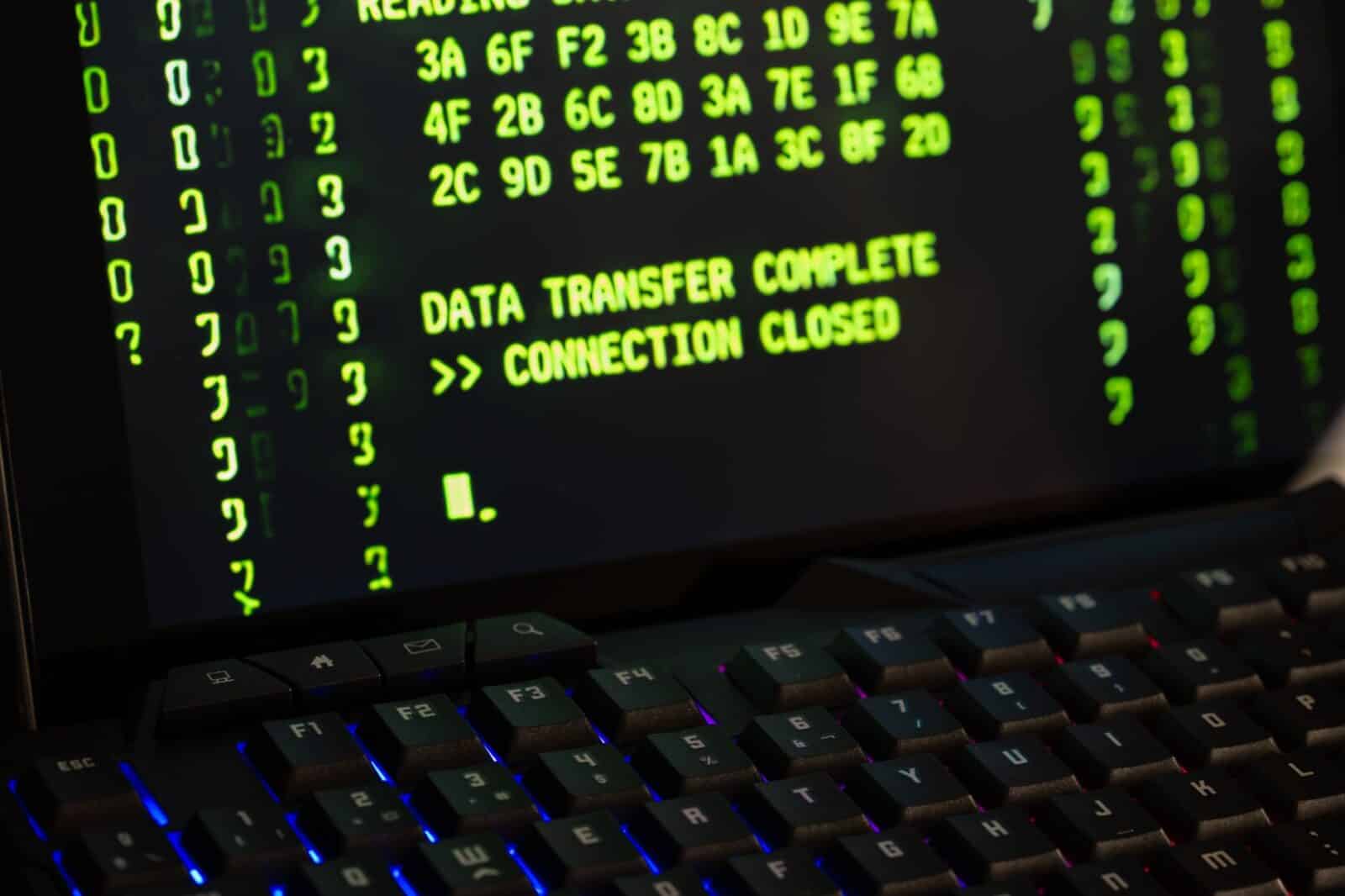 Data transfer complete message displayed on a computer monitor with a keyboard underneath.