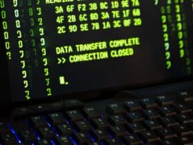 Data transfer complete message displayed on a computer monitor with a keyboard underneath.