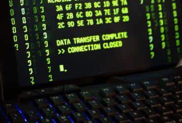 Data transfer complete message displayed on a computer monitor with a keyboard underneath.