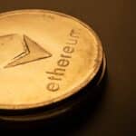 Detailed macro shot of an Ethereum logo coin against a dark background.