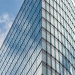 Kantoorgebouw met glazen gevel, symbool voor financieel toezicht op cryptoaanbieders