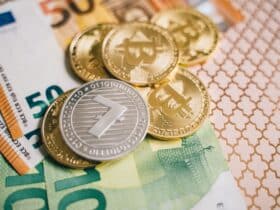 Close-up of digital cryptocurrency coins and Euro banknotes, representing modern finance.